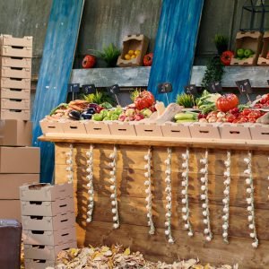 Autumn harvest fair with farmers market stand to sell fresh products, empty greenmarket stand with various fruits and veggies. Colorful raw homegrown produce, vegetables on marketplace stall.
